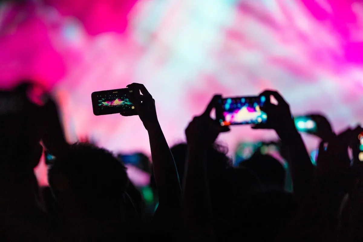 Audience members participating in a live event with phones